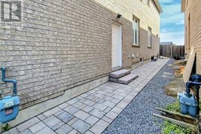 Bradford West Gwillimbury (Bradford) apartment for rent - A brick building with a white door and a small patio area.