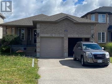 Barrie (Northwest) apartment for rent - A grey SUV is parked in front of a house with a garage.
