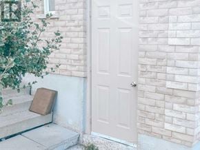 Barrie (Northwest) apartment for rent - A white door is on the right side of a white brick wall.