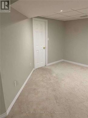 Barrie (Northwest) apartment for rent - A room with a white door and carpeted floor.