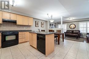 Brampton (Bram East) apartment for rent - A kitchen with black appliances and wooden cabinets.