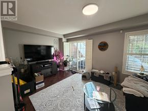 Brampton (Bram East) apartment for rent - A living room with a television, a couch, and a rug.