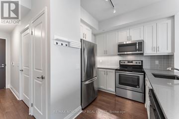 Toronto (Islington-City Centre West) condo for rent - A kitchen with white cabinets and stainless steel appliances.