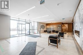 Toronto (Islington-City Centre West) condo for rent - A spacious lobby with a reception desk and chairs.