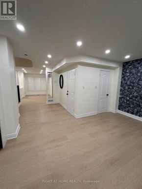 Mississauga (Churchill Meadows) apartment for rent - A hallway with white walls and wooden flooring.