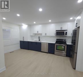 Mississauga (Churchill Meadows) apartment for rent - A modern kitchen with stainless steel appliances and white cabinets.