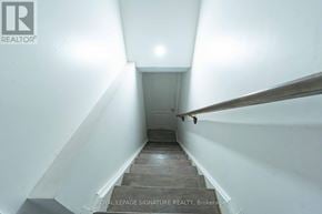 Mississauga (Creditview) multi-family for rent - A stairway with a wooden handrail leads to a door at the top.