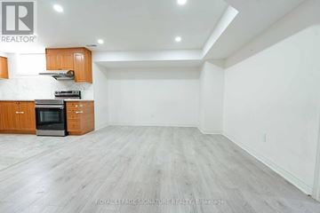 Mississauga (Creditview) multi-family for rent - A spacious kitchen with wooden cabinets and a black oven.