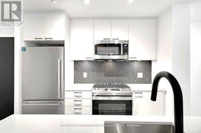 Toronto (Weston-Pellam Park) condo for rent - A modern kitchen with a stainless steel refrigerator, oven, and microwave.