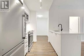 Toronto (Weston-Pellam Park) condo for rent - A modern kitchen with white cabinets and stainless steel appliances.