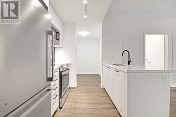 Toronto (Weston-Pellam Park) condo for rent - A modern kitchen with white cabinets and stainless steel appliances.