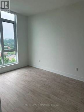 Toronto (Junction Area) condo for rent - A room with a large window and wooden flooring.