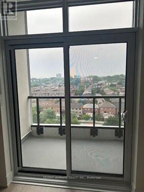 Toronto (Junction Area) condo for rent - A window with a view of a cityscape.