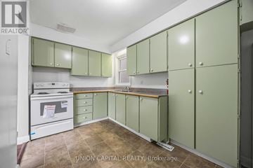 Toronto (Briar Hill-Belgravia) apartment for rent - A kitchen with green cabinets and a white oven.