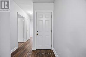 Toronto (Briar Hill-Belgravia) apartment for rent - A white door is in the middle of a hallway.