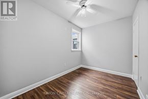 Toronto (Briar Hill-Belgravia) apartment for rent - A room with a ceiling fan and wooden flooring.