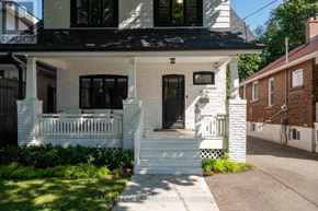 Toronto (Weston) apartment for rent - A white house with a black roof and a porch.