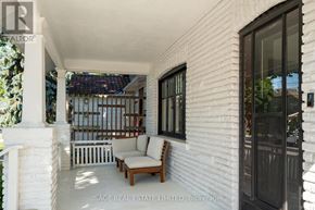 Toronto (Weston) apartment for rent - A white house with a porch and a couch.