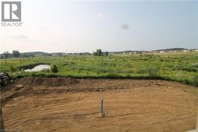 Kitchener townhouse for rent - A construction site with a dirt field and a pole in the middle.