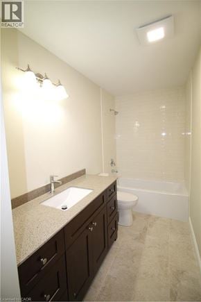 Kitchener townhouse for rent - A bathroom with a sink, toilet and bathtub.