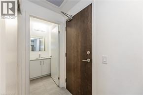 Kitchener condo for rent - A brown door is in a white hallway.