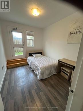 Waterloo townhouse for rent - A bedroom with a bed, desk, and window.