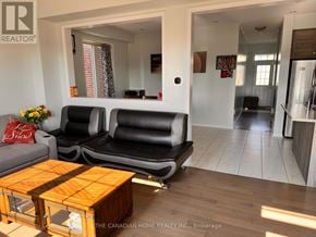 Thorold (Hurricane/Merrittville) apartment for rent - A living room with a black couch and a wooden coffee table.