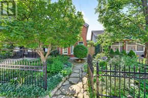 Hamilton (Stinson) apartment for rent - A garden with a brick pathway and a metal fence.