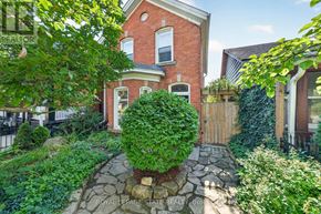 Hamilton (Stinson) apartment for rent - A red brick house with a garden in front.