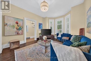 Hamilton (Stinson) apartment for rent - A living room with a blue couch and a glass coffee table.