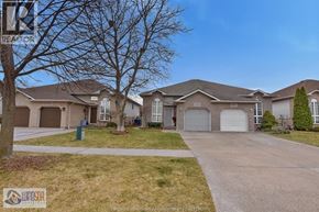 Windsor apartment for rent - A residential area with houses and a tree.
