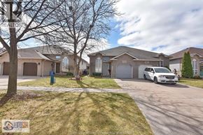 Windsor apartment for rent - A residential area with houses and a parked car.