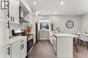 Essex apartment for rent - A modern kitchen with white cabinets and a large island.