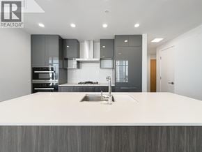 Burnaby apartment for rent - A modern kitchen with a large island and stainless steel appliances.