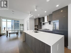 Burnaby apartment for rent - A modern kitchen with a large island and a dining area.