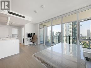 Burnaby apartment for rent - A modern living room with a large glass door leading to a balcony.
