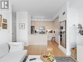 Toronto (Willowdale East) condo for rent - A modern kitchen with white cabinets and appliances.