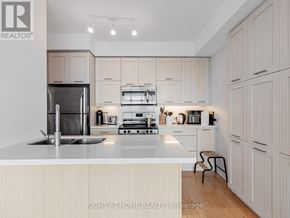 Toronto (Willowdale East) condo for rent - A modern kitchen with a stainless steel refrigerator, oven, and sink.
