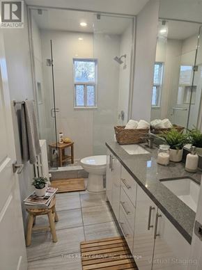 Toronto (Bedford Park-Nortown) multi-family for rent - A bathroom with a glass shower stall and a toilet.