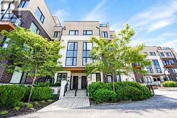 Pickering (Town Centre) townhouse for rent - A modern building with a front yard and a clear blue sky.
