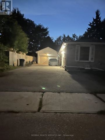 Brampton (Madoc) apartment for rent - A house with a garage is illuminated by lights at night.