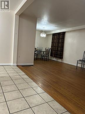 Brampton (Madoc) apartment for rent - A room with a wooden floor and a white tiled floor.