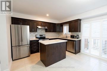 Mississauga (Hurontario) townhouse for rent - A modern kitchen with dark brown cabinets and stainless steel appliances.