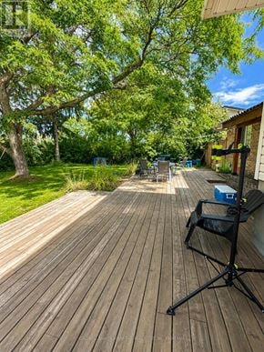 Welland (N. Welland) apartment for rent - A wooden deck with a black folding chair and a blue cooler box.