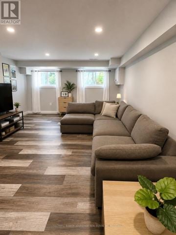 Welland (N. Welland) apartment for rent - A living room with a long couch and a television.