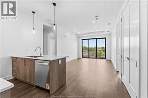 Windsor condo for rent - A modern kitchen with wooden floors and white walls.