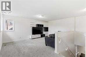 Calgary apartment for rent - A living room with a television and a couch.