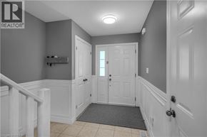 Brantford townhouse for rent - A hallway with a white door and a light on the ceiling.