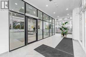 Guelph (St. Patrick's Ward) condo for rent - A modern office lobby with glass walls and a black and white rug.