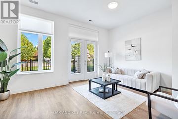 London East (East K) condo for rent - A living room with a white couch and a coffee table in the center.